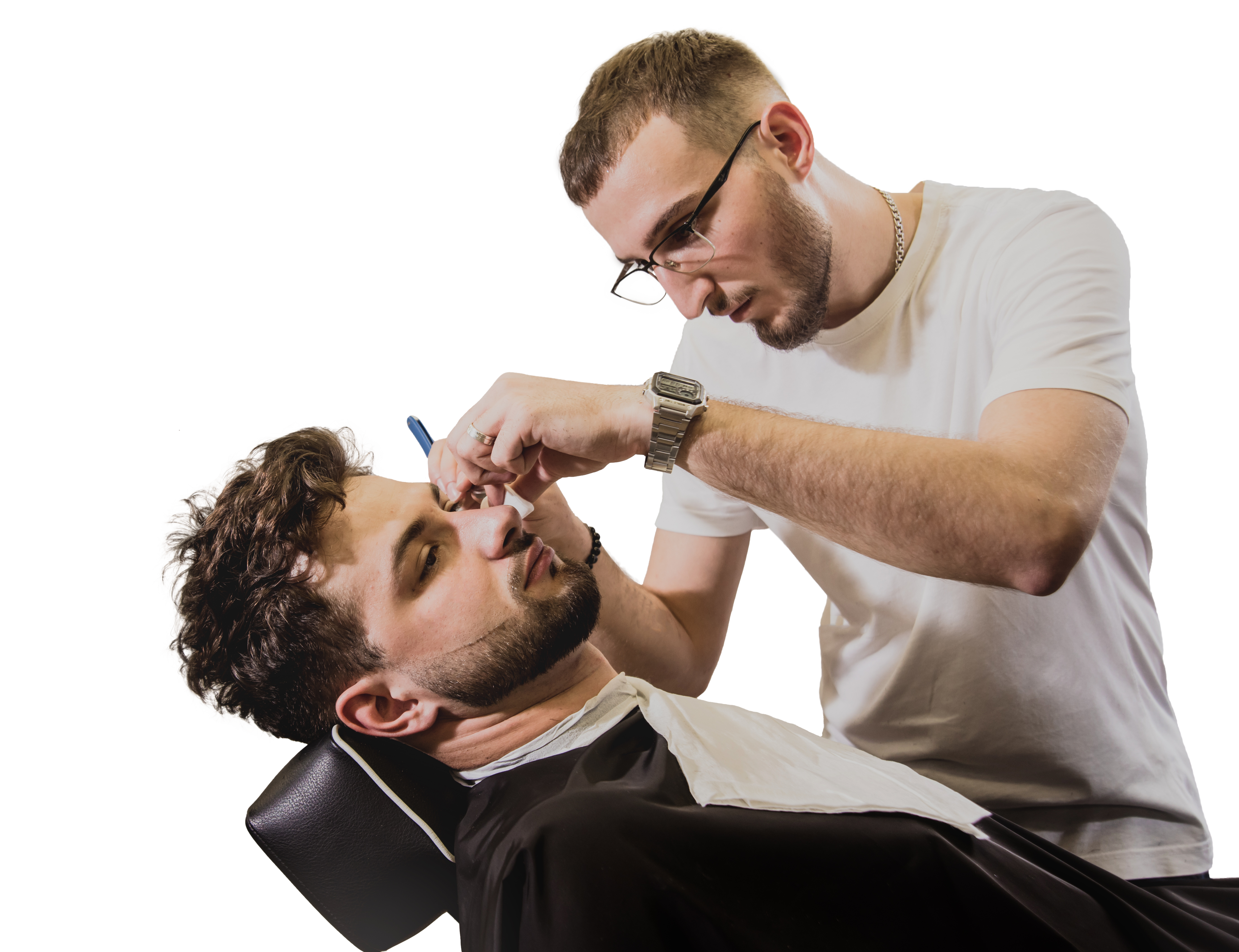 A professional barber lining up a client’s beard. 